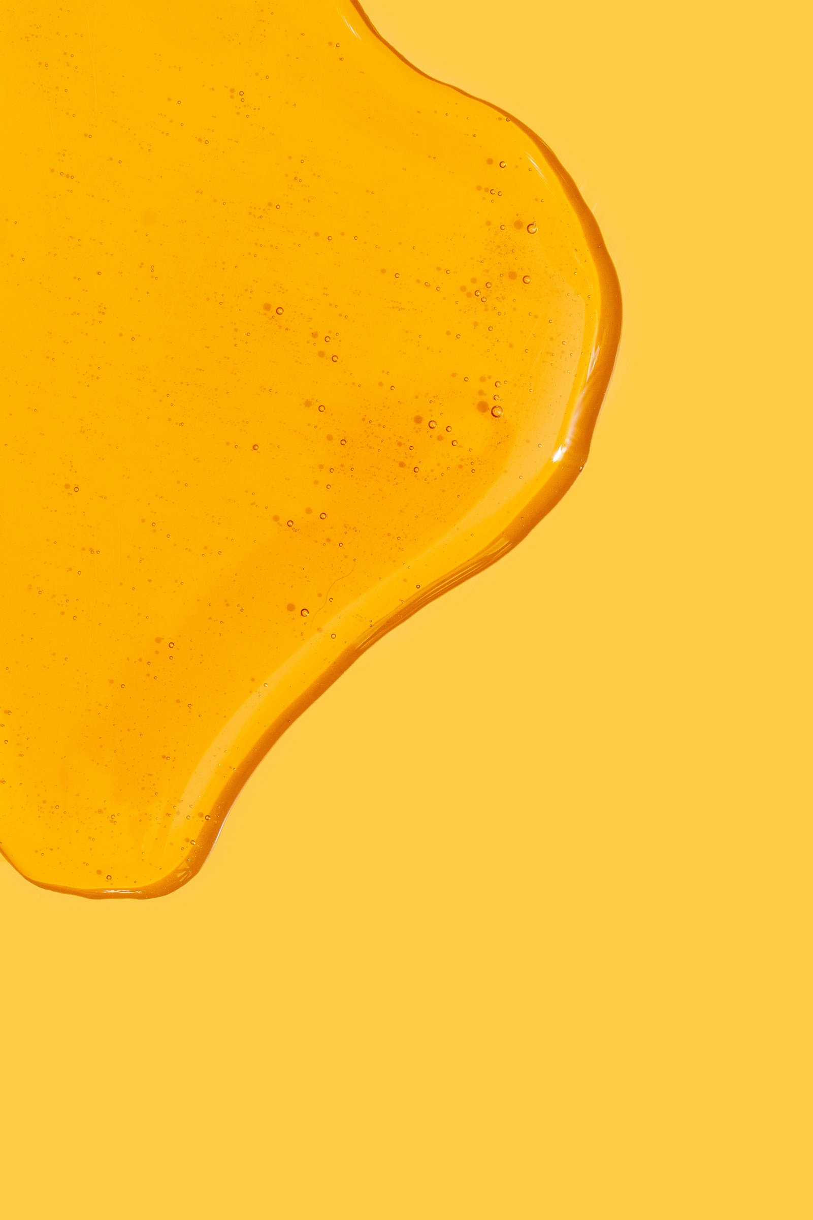 Honey or Gel on Yellow Background 